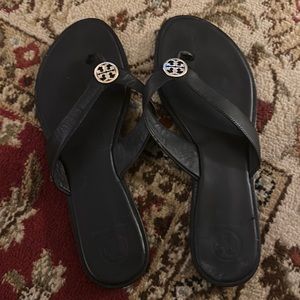 Black and gold leather Tory Burch thong sandals..